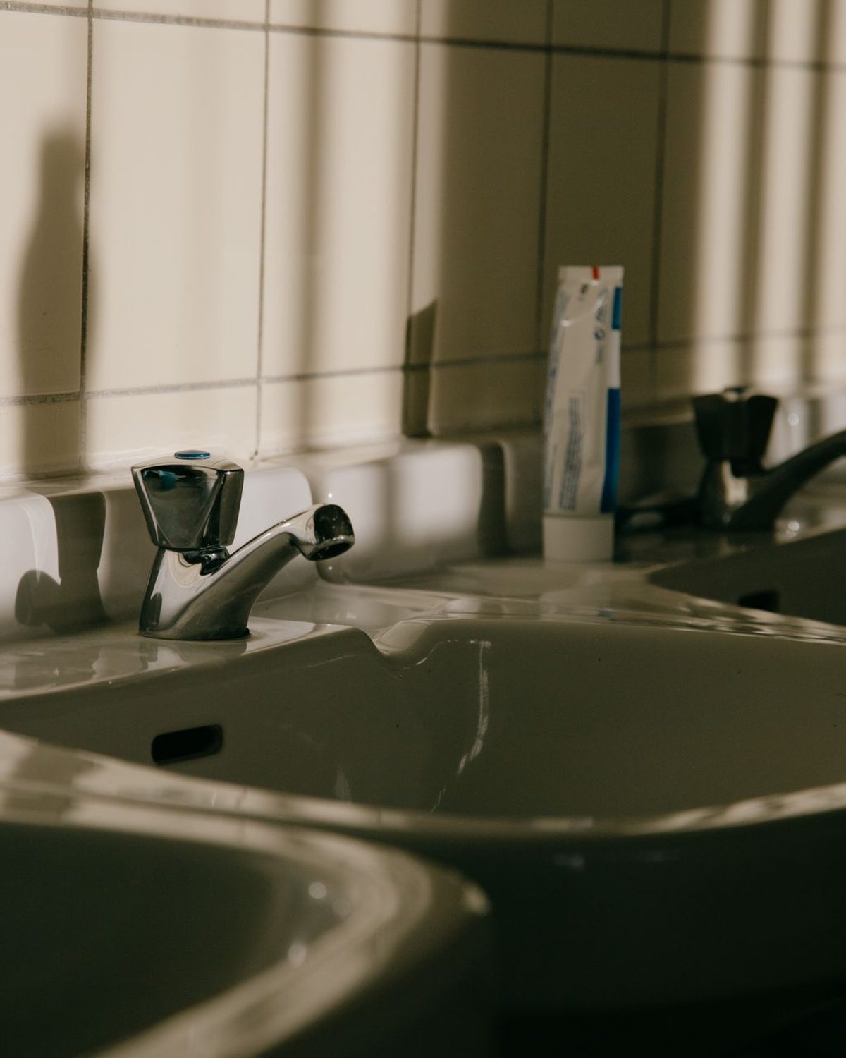 Row of white basins in a washroom